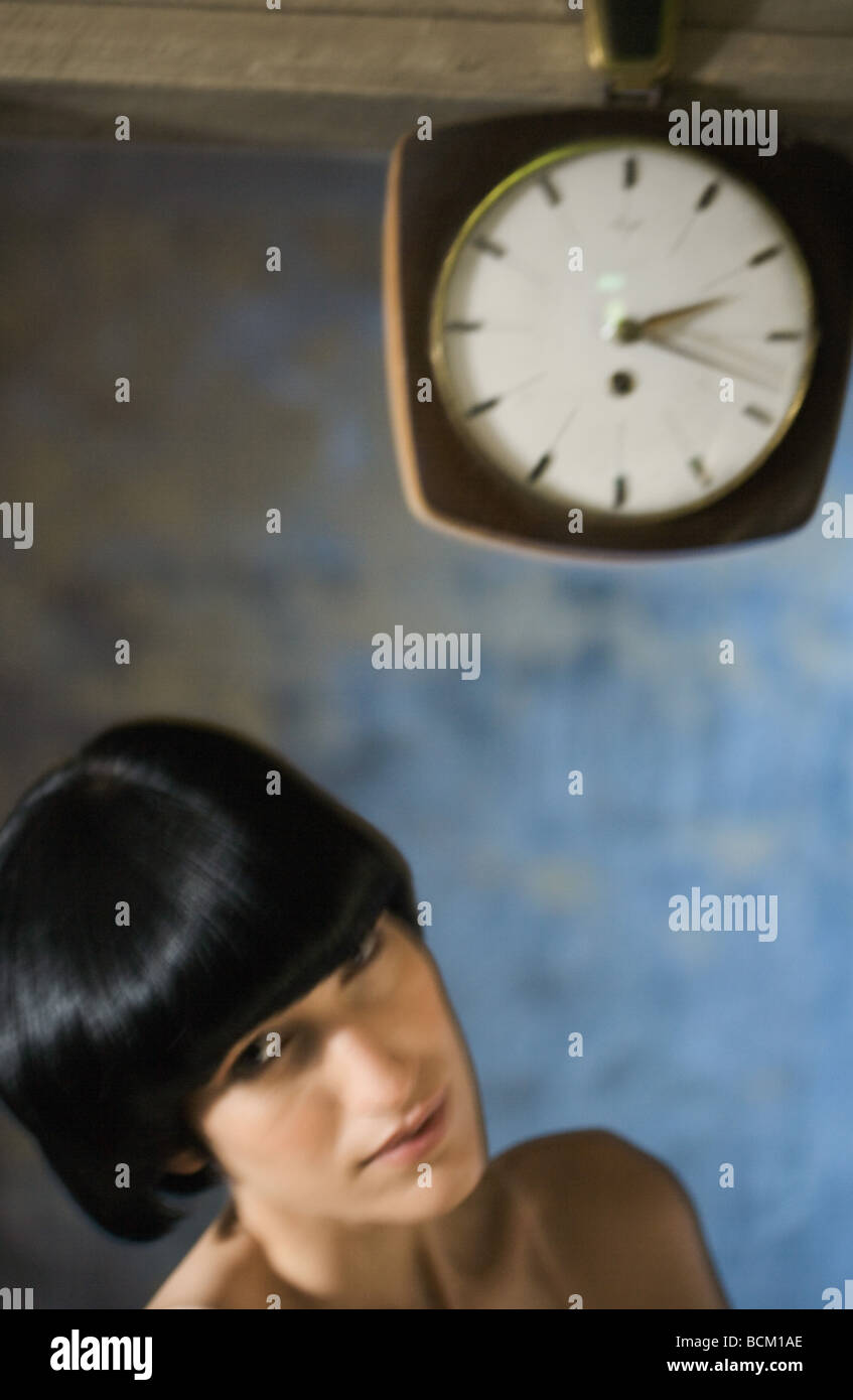 Woman beneath clock, head and shoulders Stock Photo - Alamy
