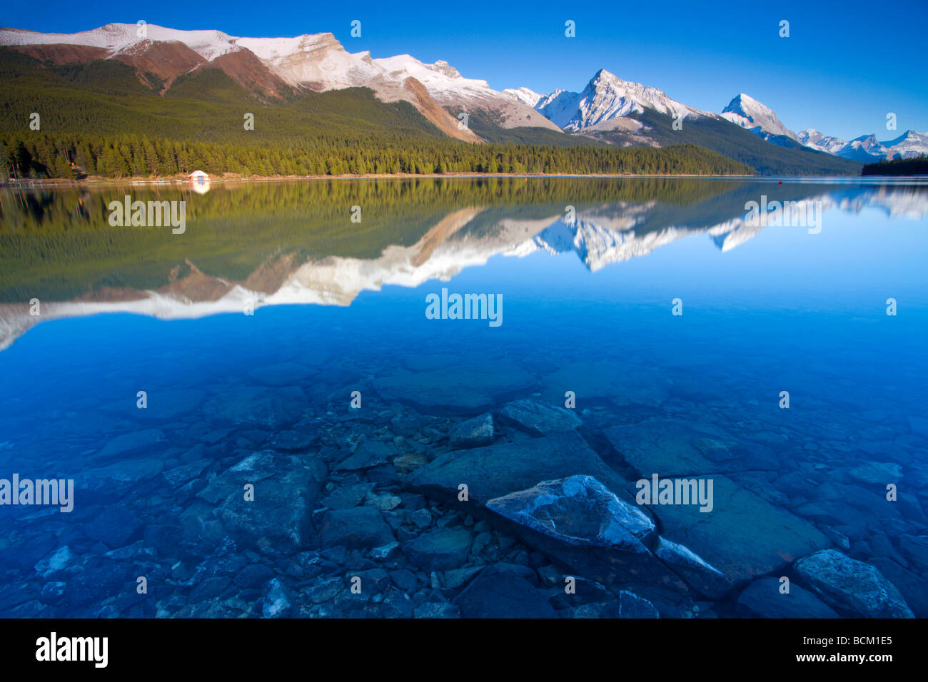 Crystal clear water with reflections at Maligne Lake Canadian Rockies Jasper National Park Alberta Canada October 2006 Stock Photo