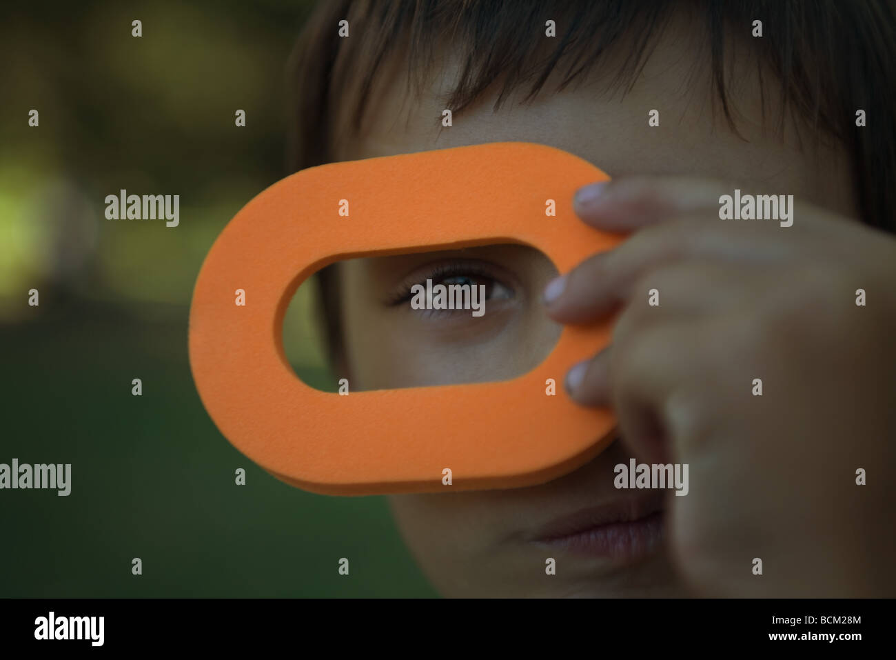 Little boy looking at camera through toy loop, close-up Stock Photo - Alamy