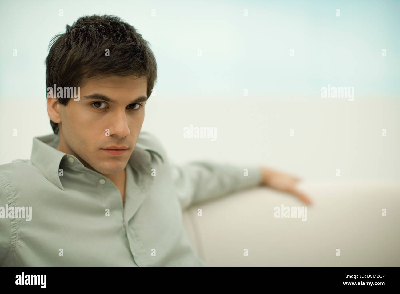 Man looking arrogantly at camera, portrait Stock Photo