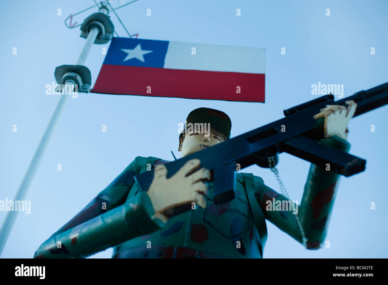 Soldier figurine holding rifle beneath Chilean flag Stock Photo