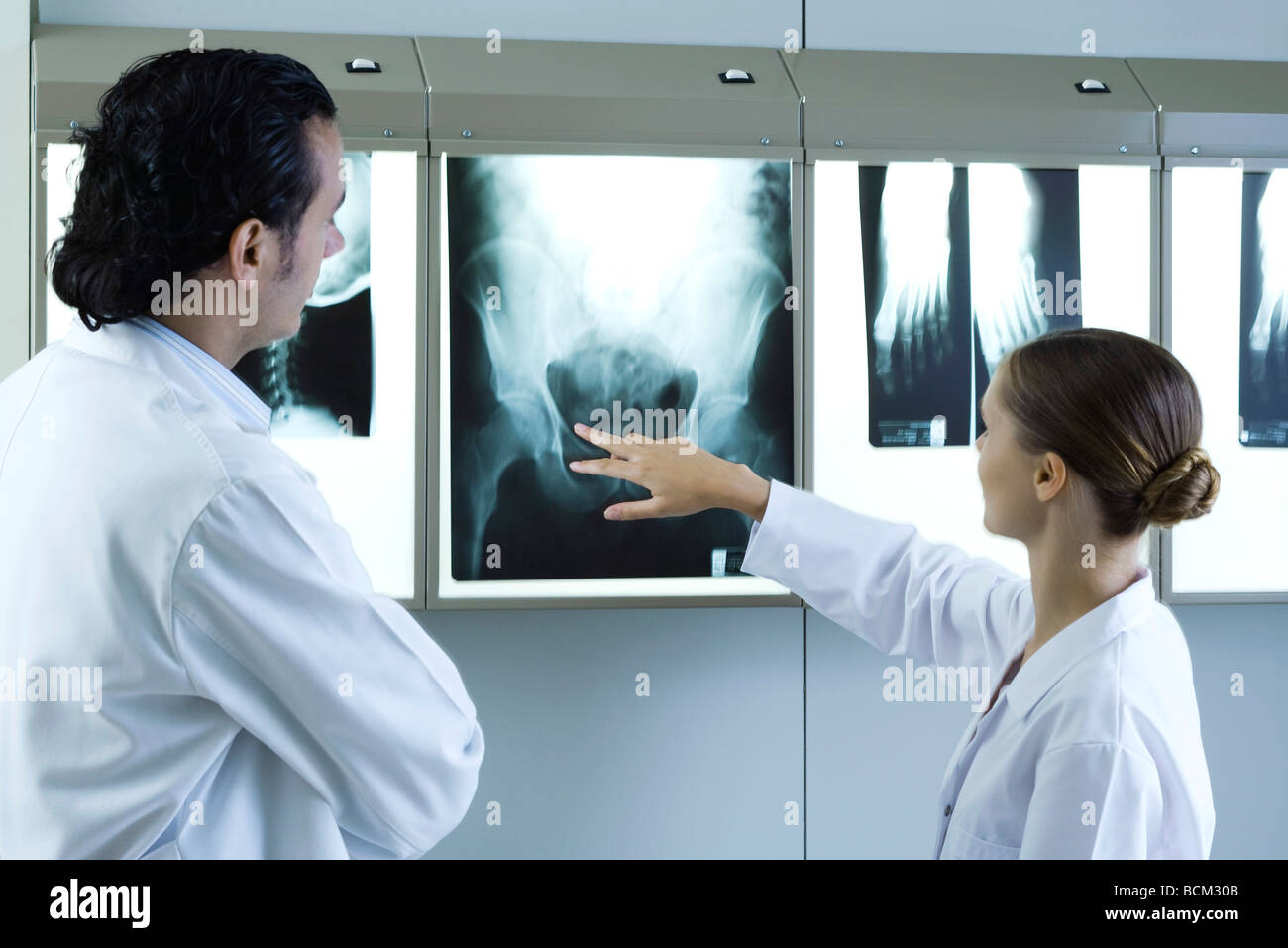Medical colleagues discussing xrays on lightbox Stock Photo Alamy