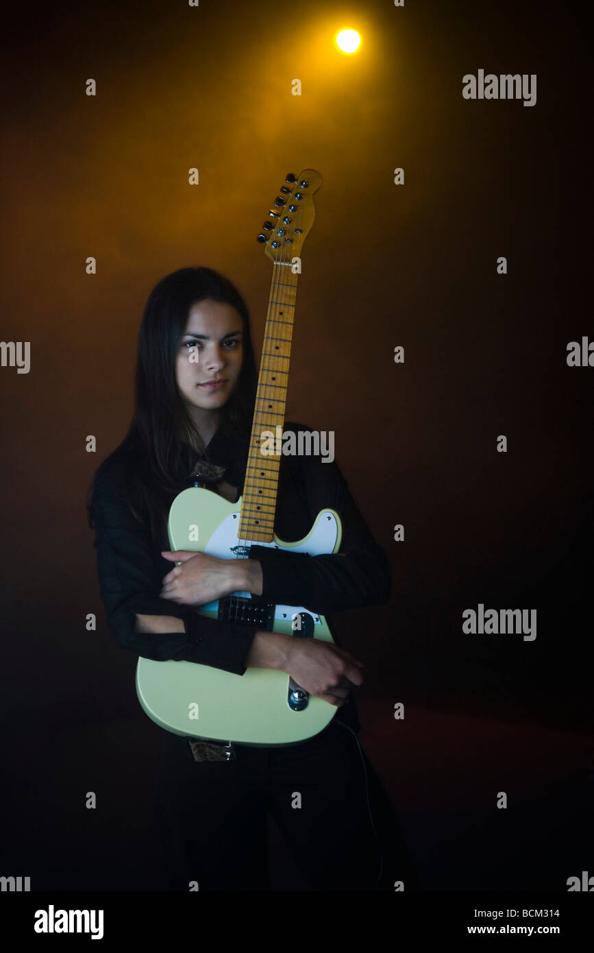 Female holding electric guitar, portrait Stock Photo Alamy