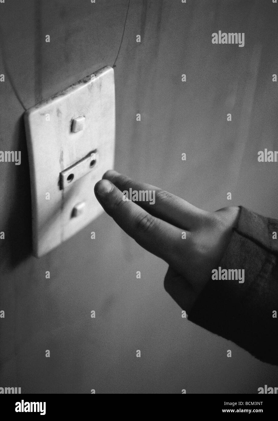 Child reaching for electric outlet Stock Photo