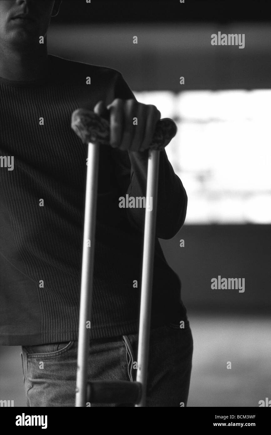 Man standing with crutch Stock Photo