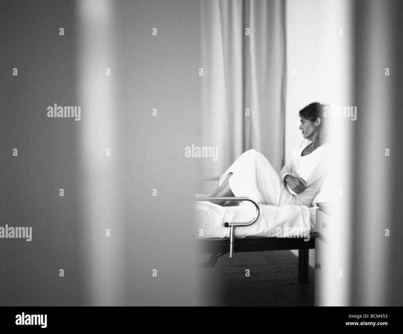 Woman reclining on hospital bed Black and White Stock Photos & Images