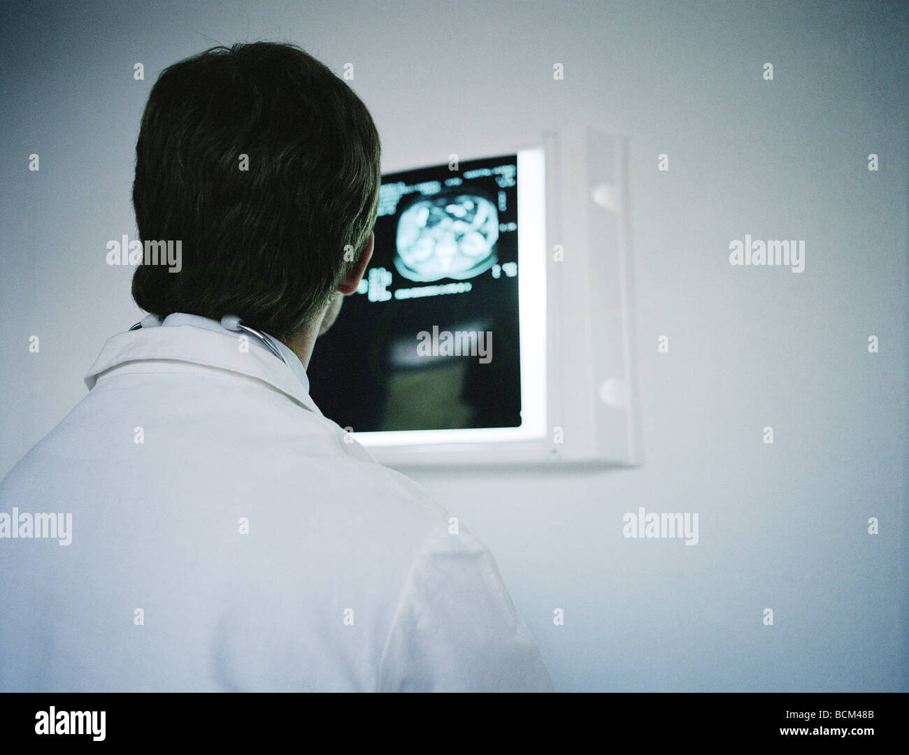 Doctor looking at MRI image, over the shoulder view Stock Photo