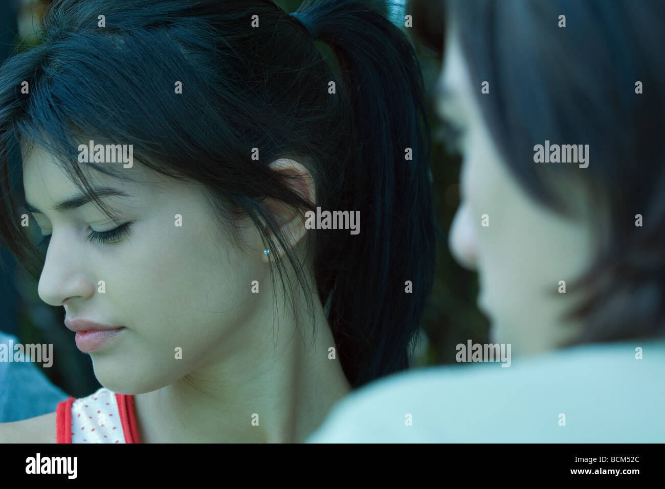 Young woman turning head away from teen boy, cropped view Stock Photo