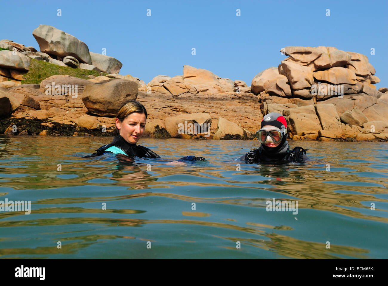 Ready to scuba dive and surrounded by big granitic rocks hi-res stock ...