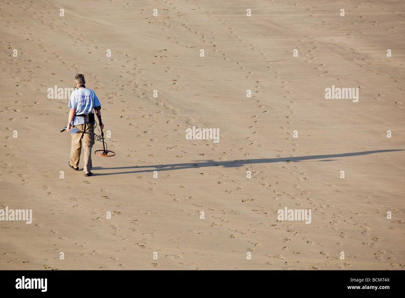 Beachcombing with Metal Detector Stock Photo