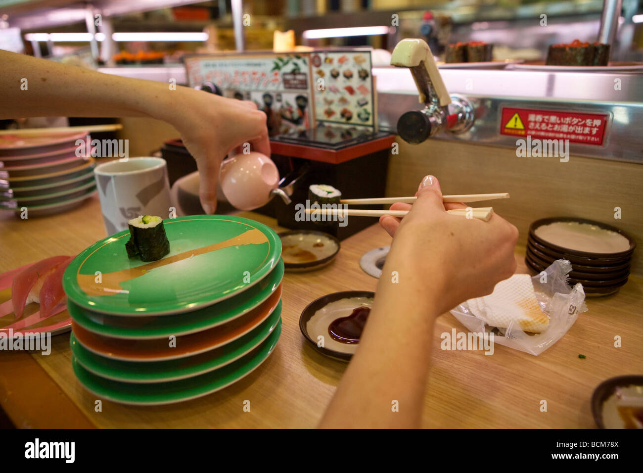 Eating conveyor belt sushi in Tokyo Japan Stock Photo