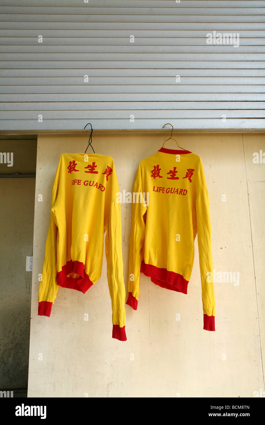 Life saving t shirt uniform clothes uniform yellow hanging drying Stock