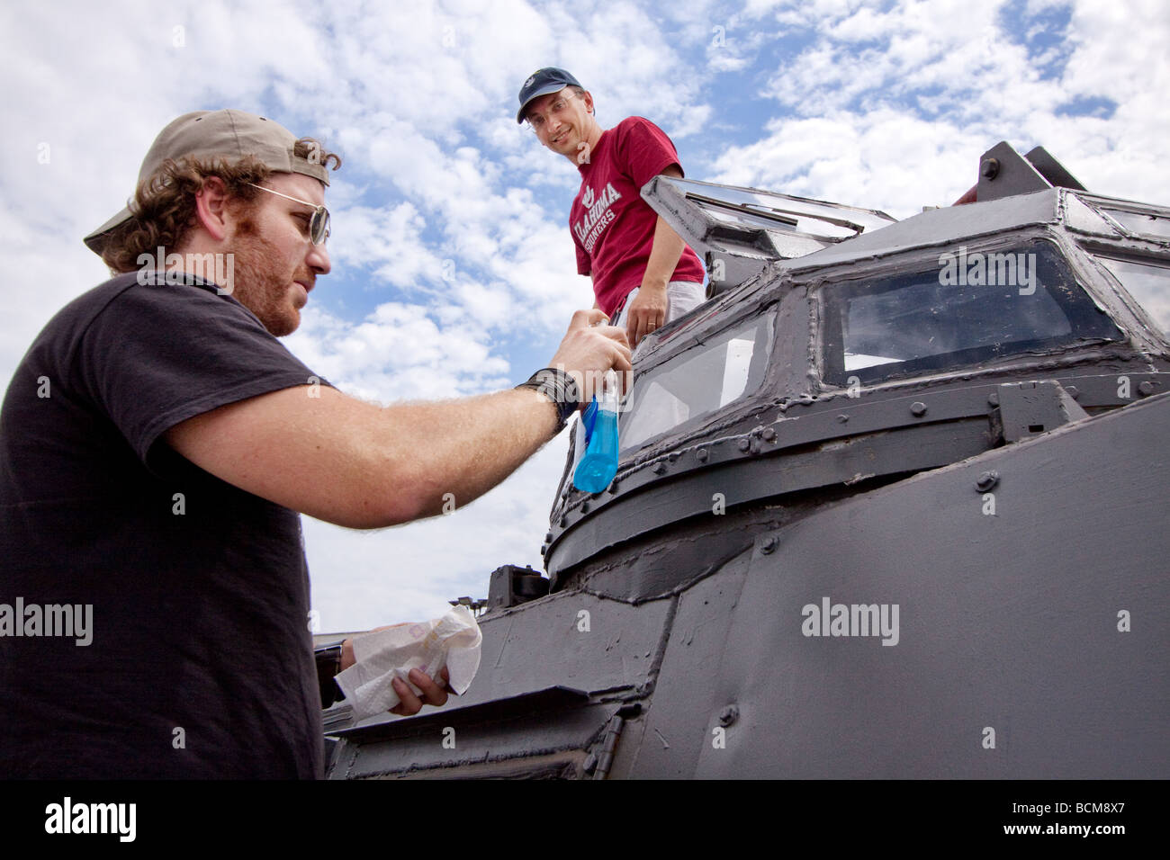 Byron Turk washes the bulletproof glass windows of storm chaser Sean ...