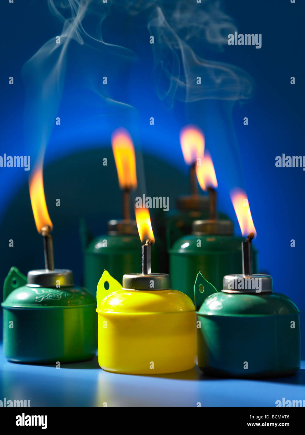 burning oil lamp on blue background Stock Photo Alamy