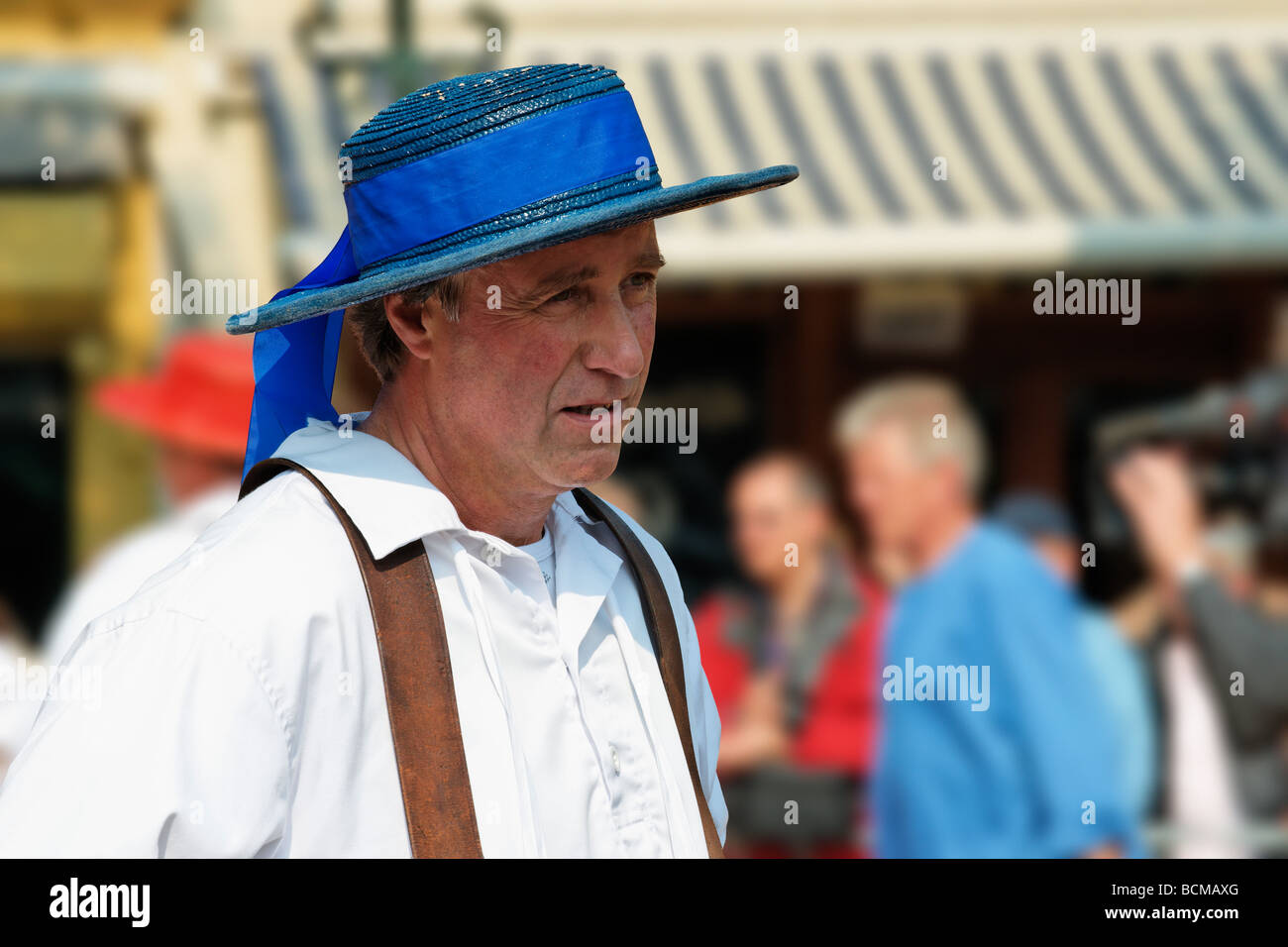 Blue hatted cheese carrier at the Alkmaar Cheesemarket, Alkmaar, North Holland, Netherlands. Stock Photo