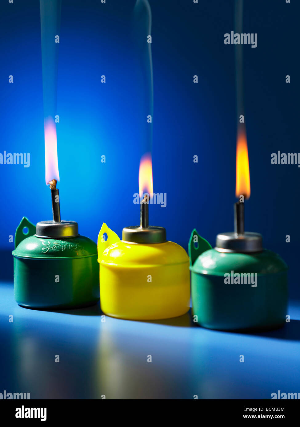 burning oil lamp on blue background Stock Photo Alamy