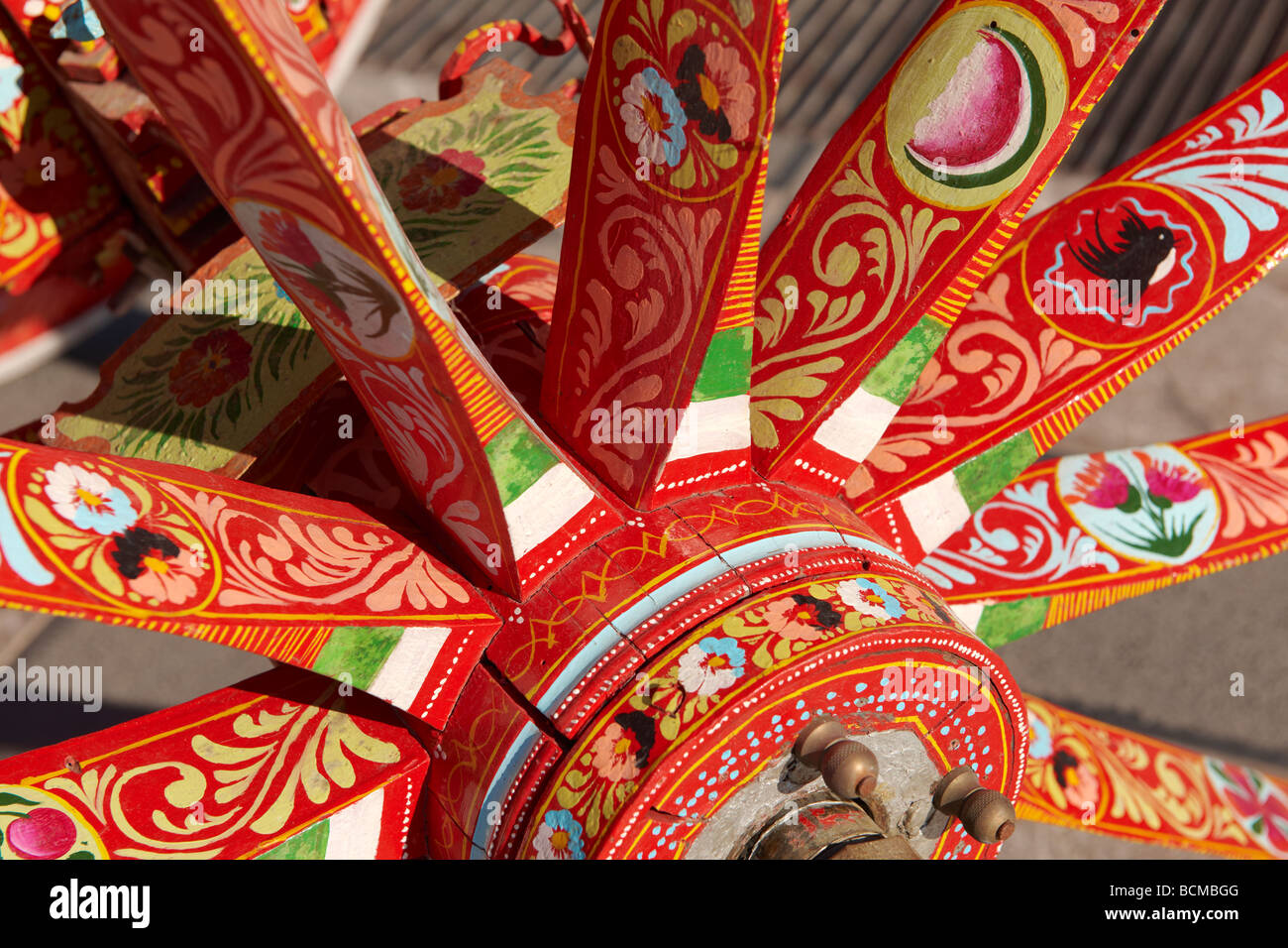 Traditional Sicilian folk art on a wooden cart wheel spokes Stock Photo