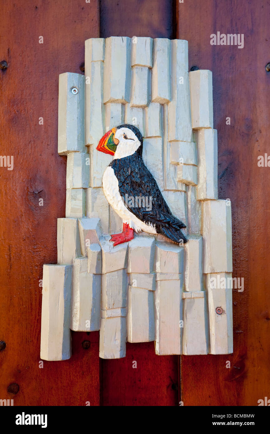 A carved wooden puffin sign shot on location in Iceland Stock Photo