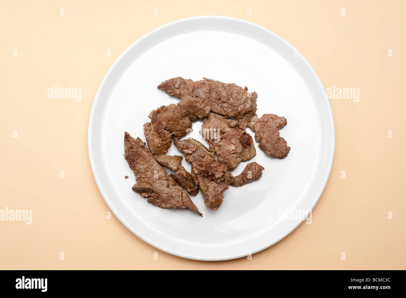 fresh cooked 'lambs liver' on a plain white plate Stock Photo