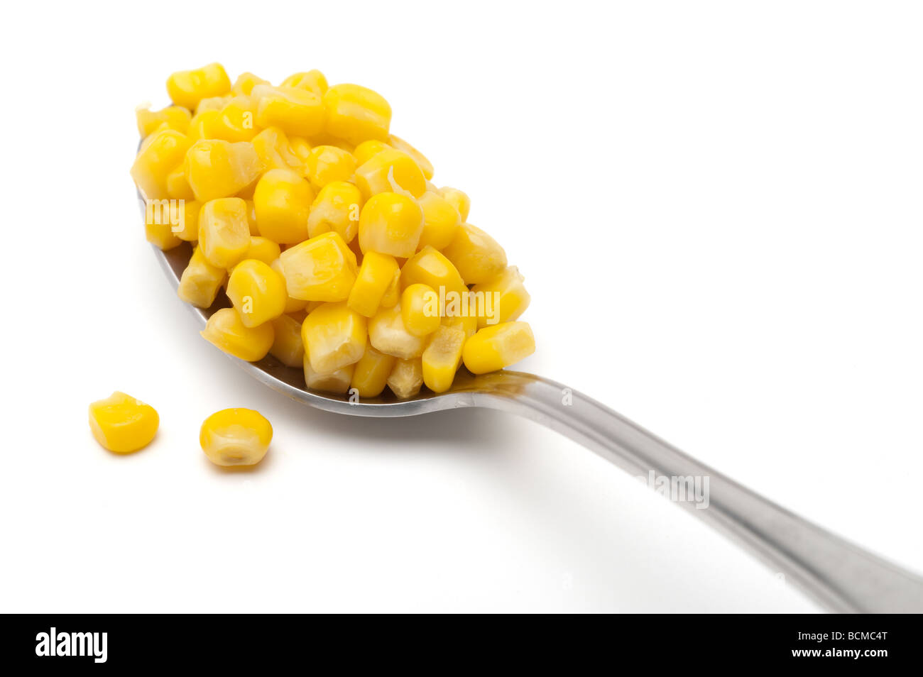 Heaped spoonful of sweetcorn Stock Photo