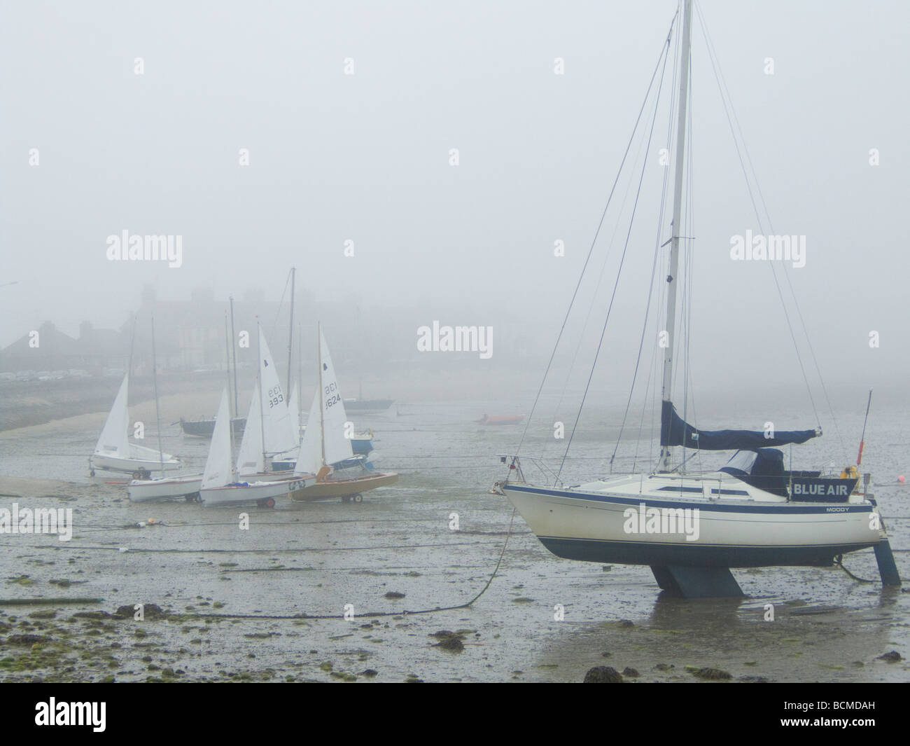 Sailing dinghies waiting for the mist to lift before setting out