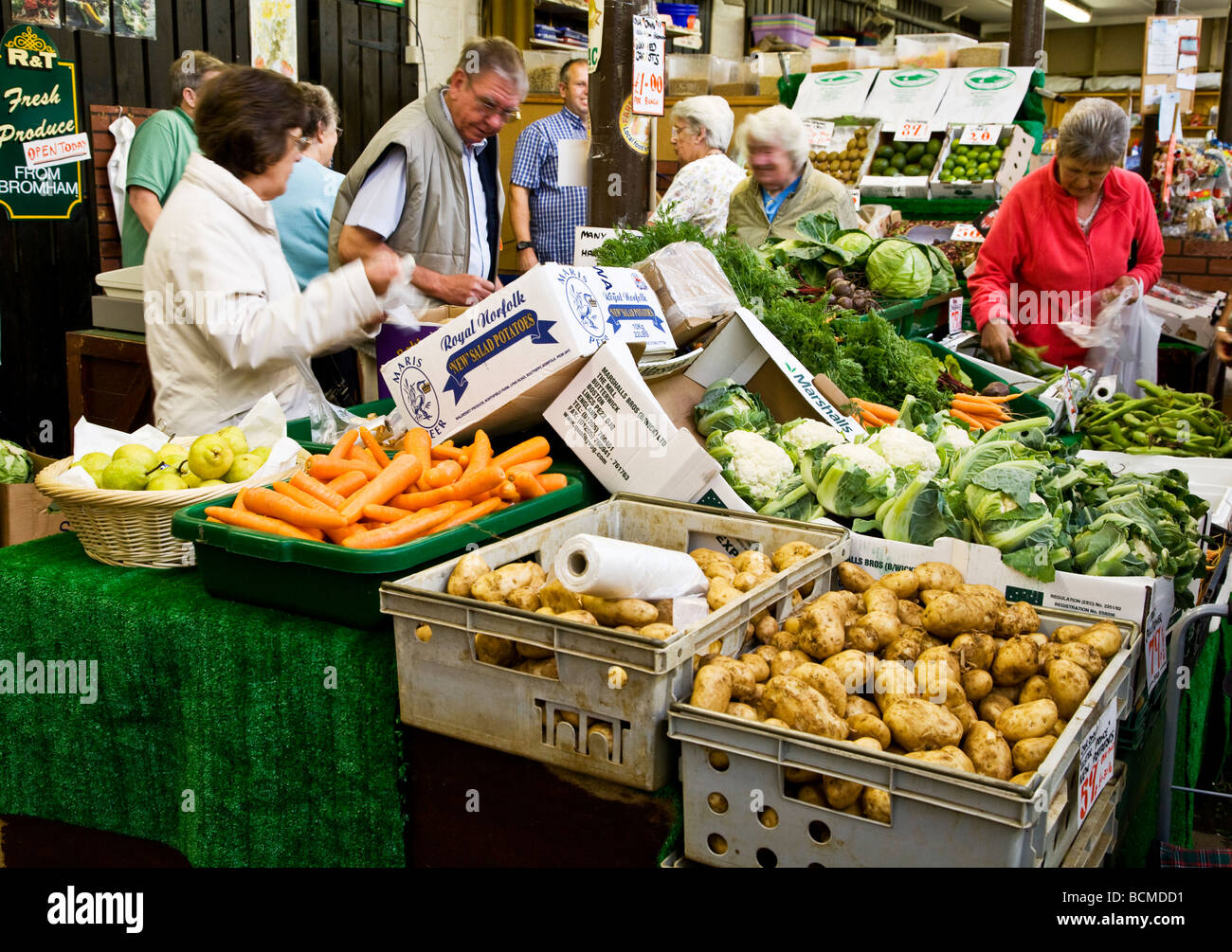 A greengrocers stall at the Shambles Indoor market in the typical English market town of Devizes Wiltshire England UK Stock Photo