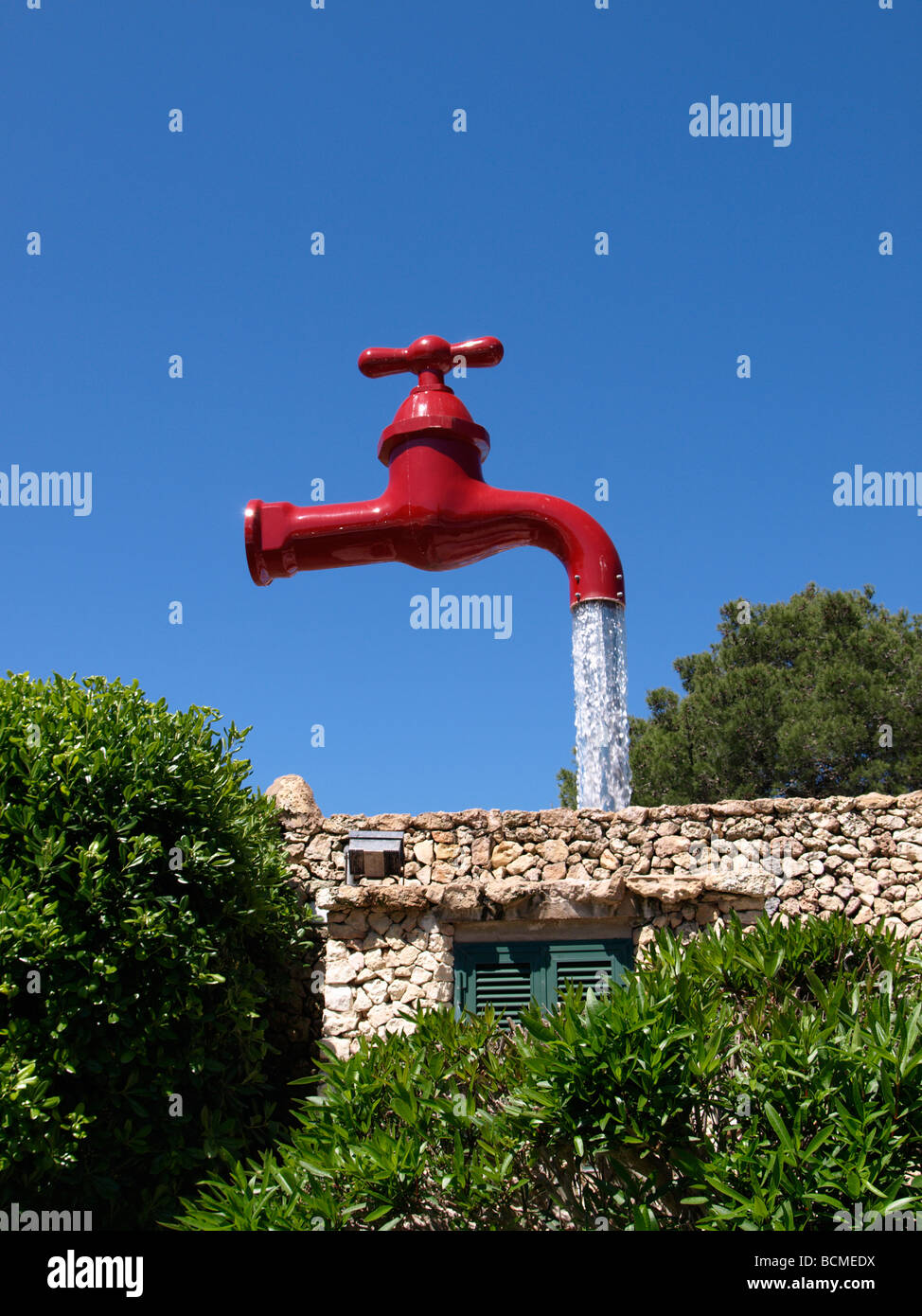 Giant red tap fountain, Cala Galdana, Menorca, Spain Stock Photo