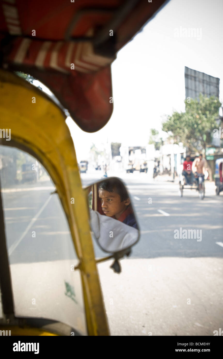 Boy in rear view mirror of auto rickshaw bangladesh Stock Photo Alamy