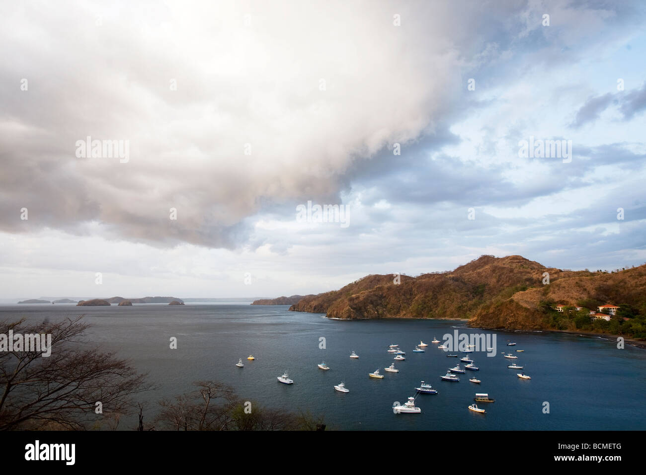 A view looking north from above of Ocotal Bay with many boats moored