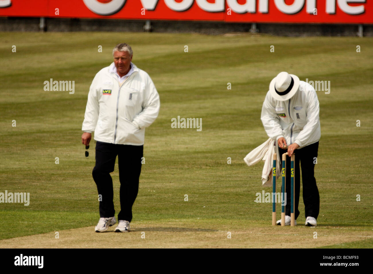 Umpires, Mike 'Pasty' Harris & Richard Kettleborough, putting on the bails before a session of County Championship Cricket Stock Photo