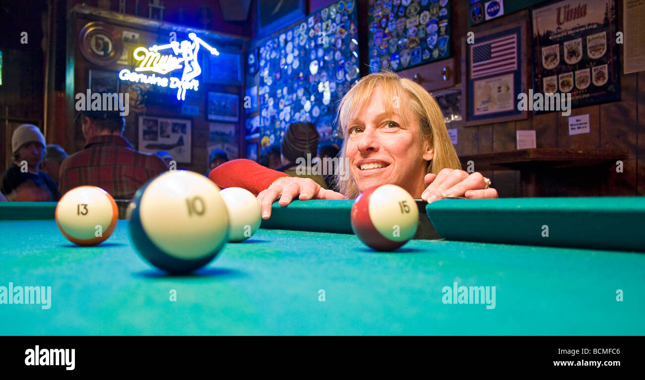 Woman has fun at pool table in Shooting Star Saloon in Huntsville, Utah
