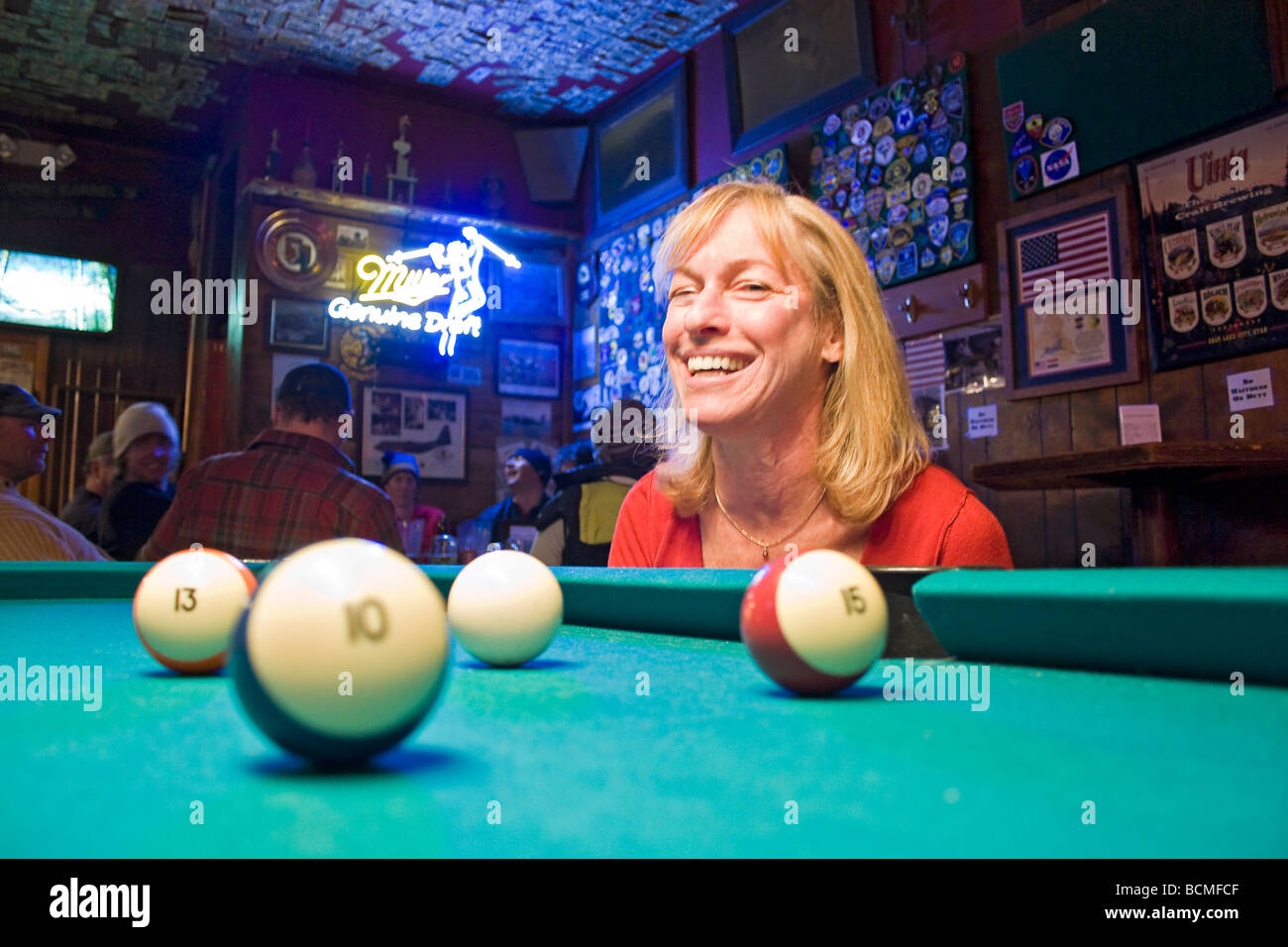 Woman has fun at pool table in Shooting Star Saloon in Huntsville, Utah