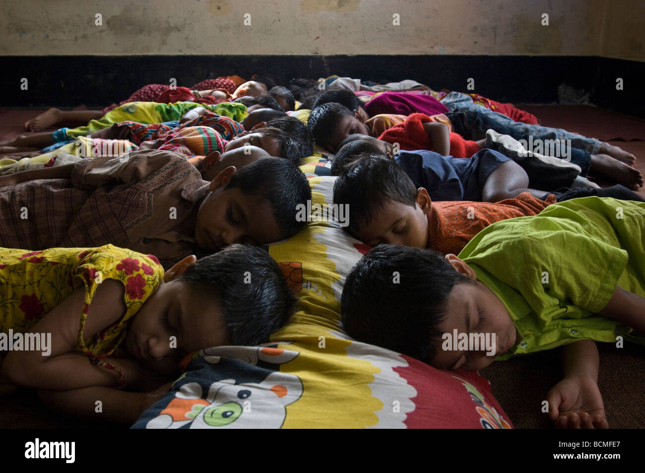 children-sleeping-on-floor-of-shelter-jamalpur-bangladesh-stock-photo