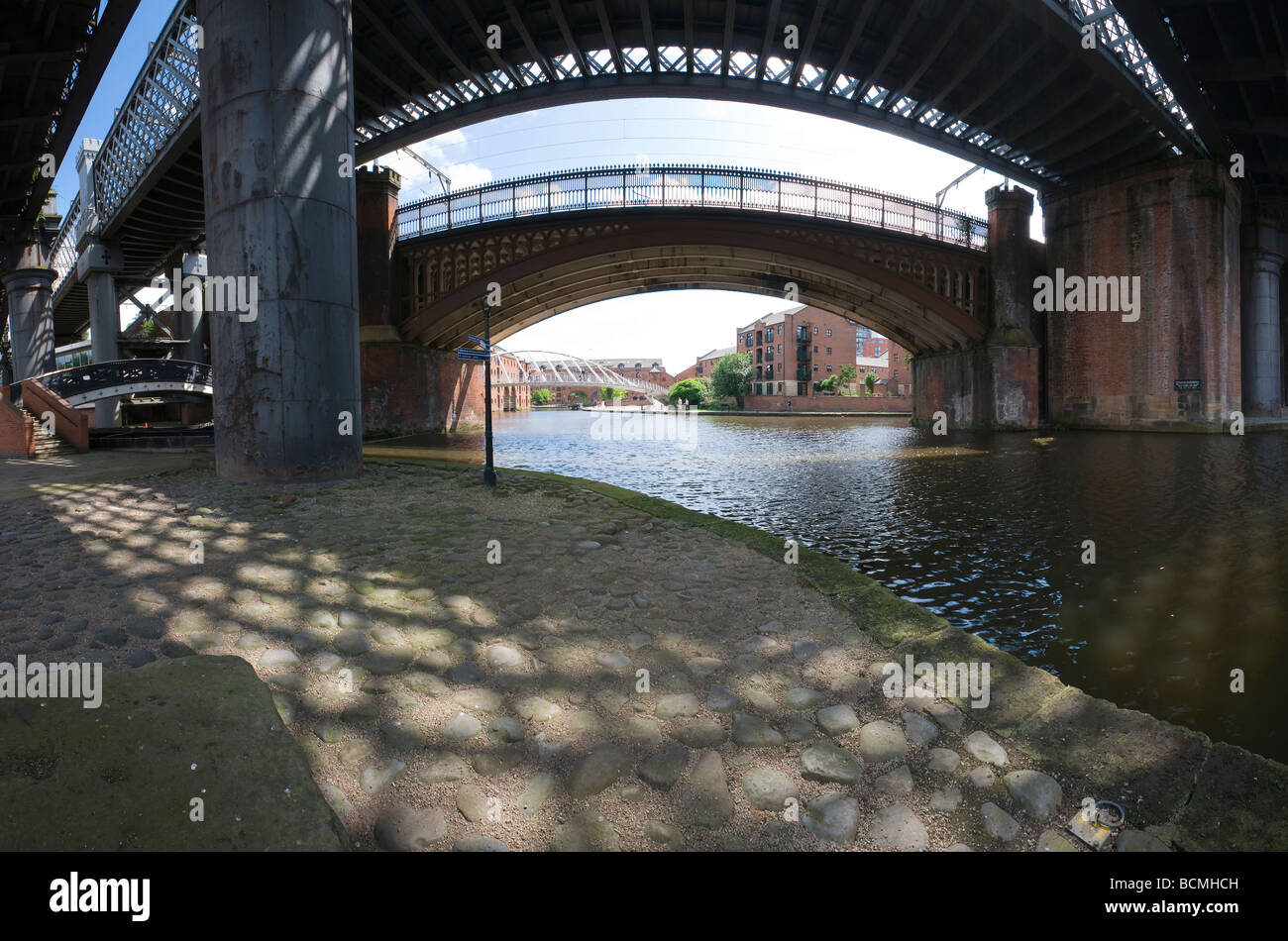 Looking through Victorian railway viaducts towards the Merchants Bridge in the Castlefield basin Manchester Stock Photo