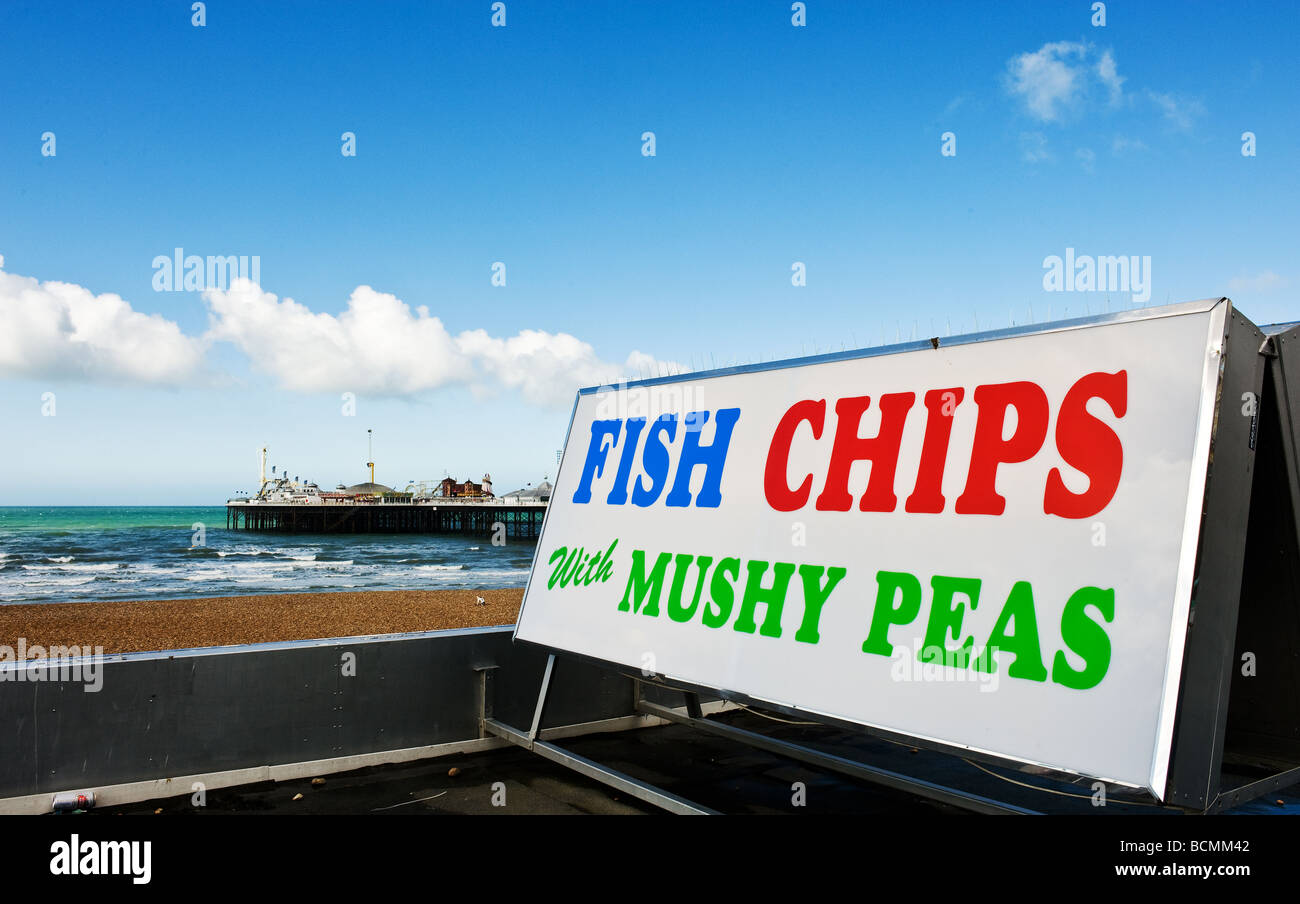 A sign advertising fish and chips and mushy peas on Brighton seafront in East Sussex. Stock Photo