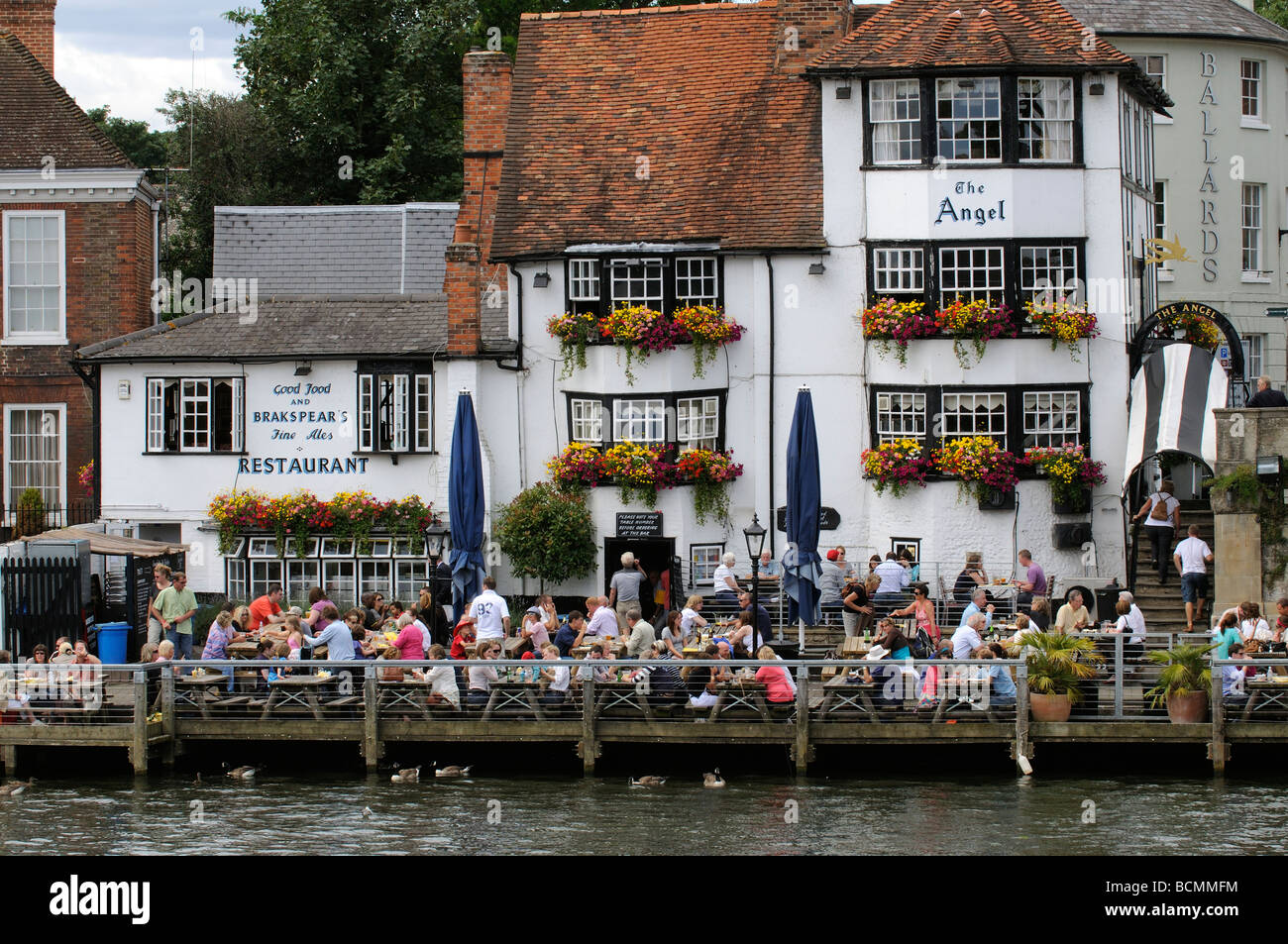 English riverside pub people eating drinking outside The Angel public house at Henley on Thames Oxfordshire England UK Stock Photo