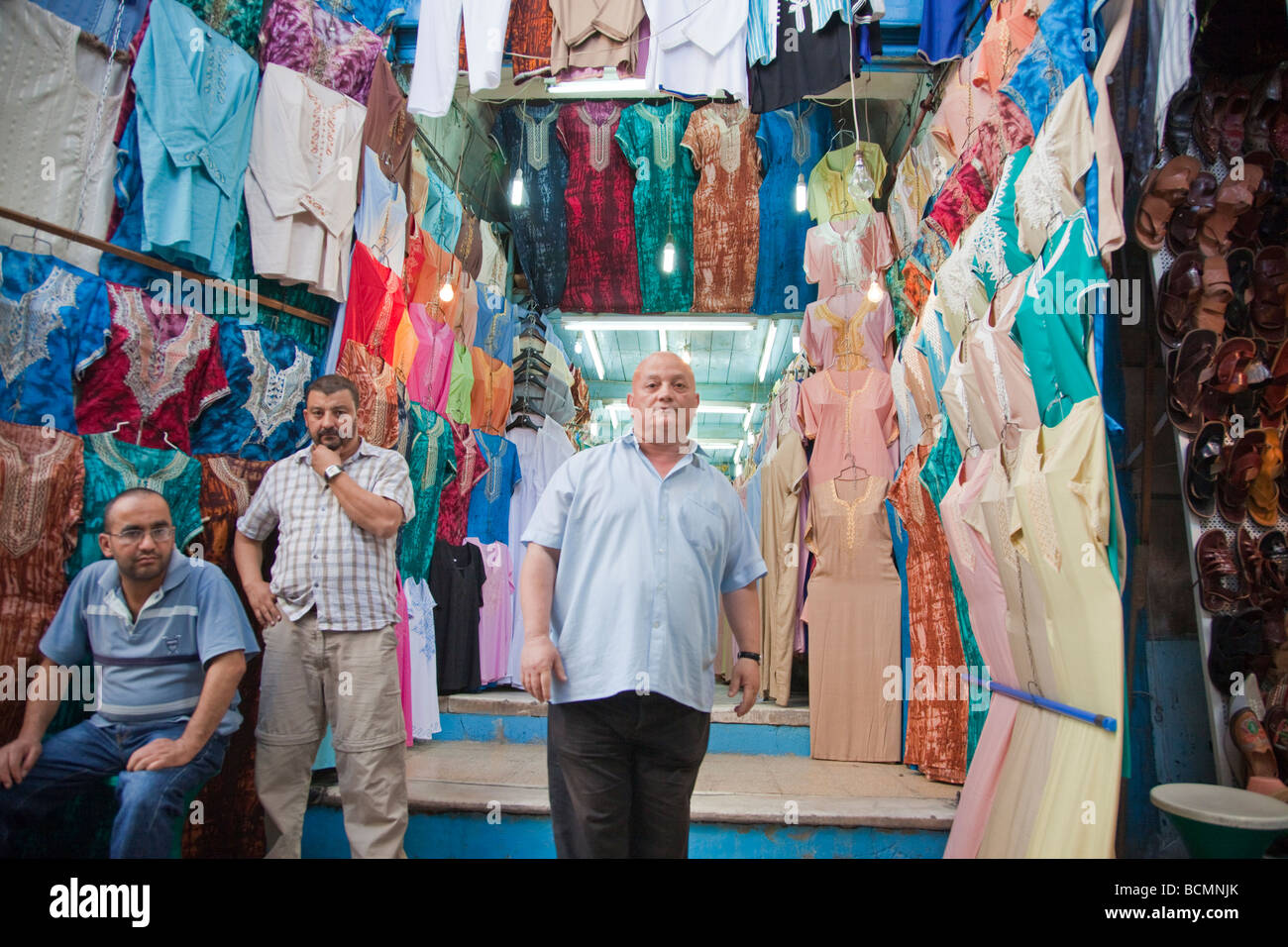A shopkeeper sells traditional Tunisian clothing in the Medina (old city) in Tunis. Stock Photo