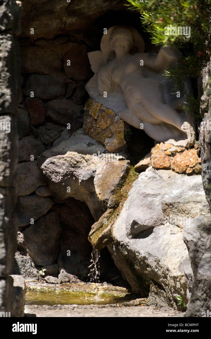 Ischia, italy - Marble sculpture of Aphrodite draped over a fountain stream La Mortella Garden Stock Photo