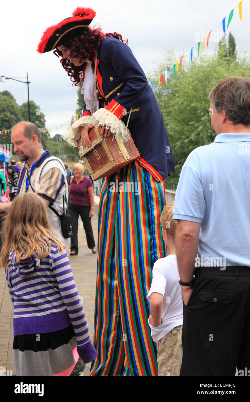 Woman dressed as pirate and walking on stilts at Regatta celebrations in Kingston upon Thames Surrey England Stock Photo