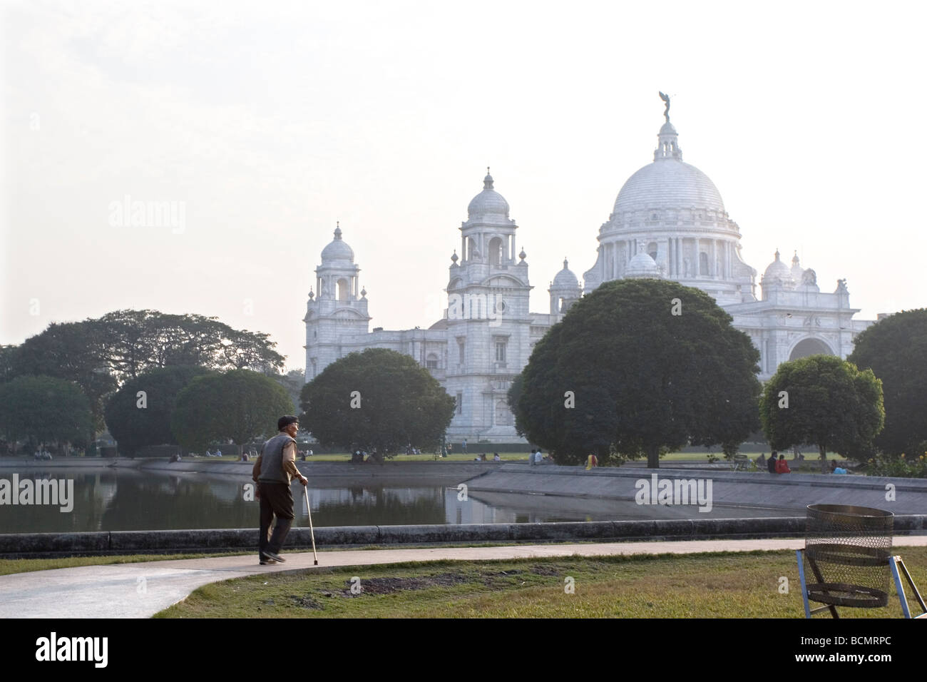 An aged man enjoys walking in front of the famous Victoria Memorial Hall,a favourite landmark of Kolkata,West Bengal,India Stock Photo