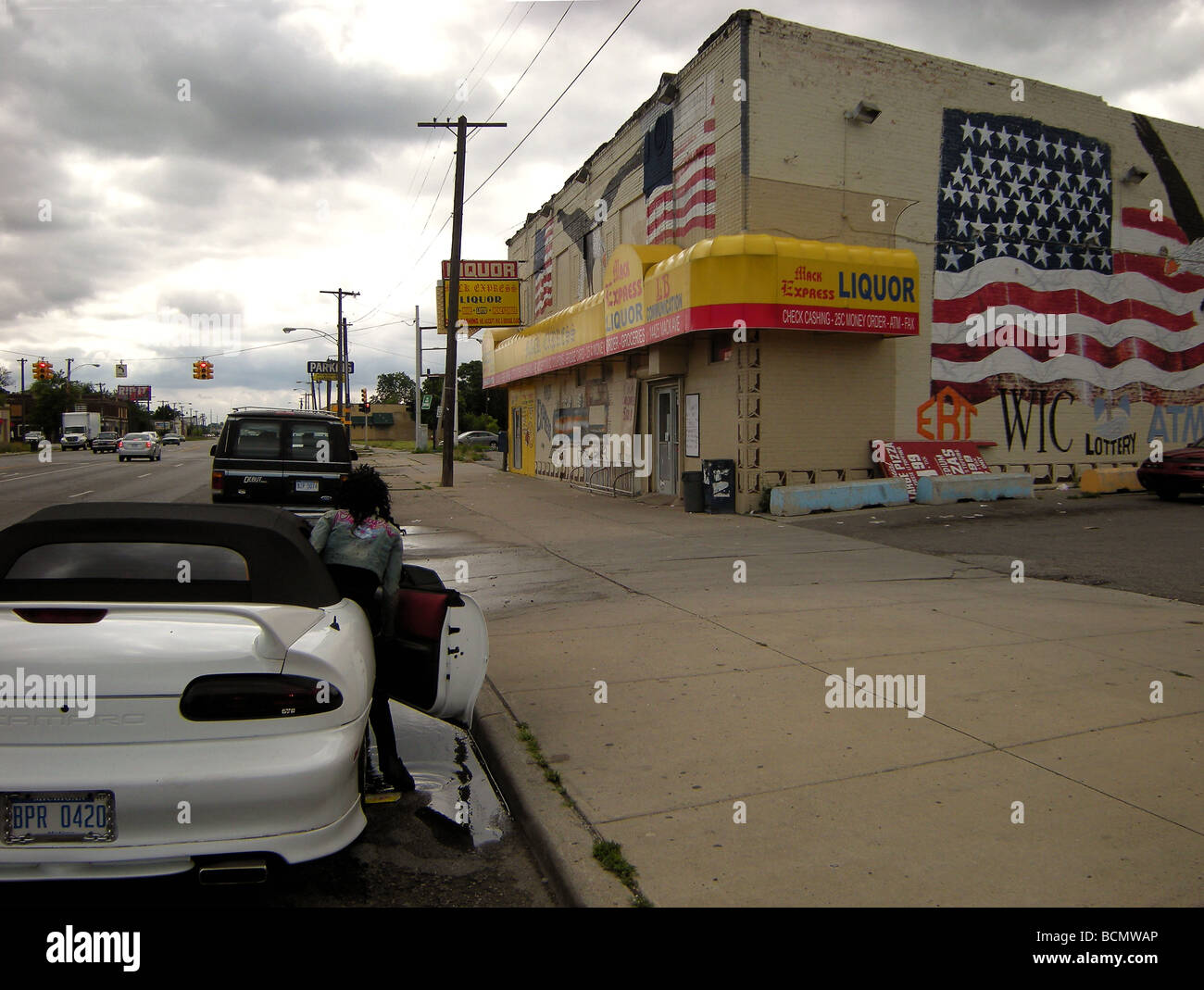 Woman in front of liquor store Stock Photo