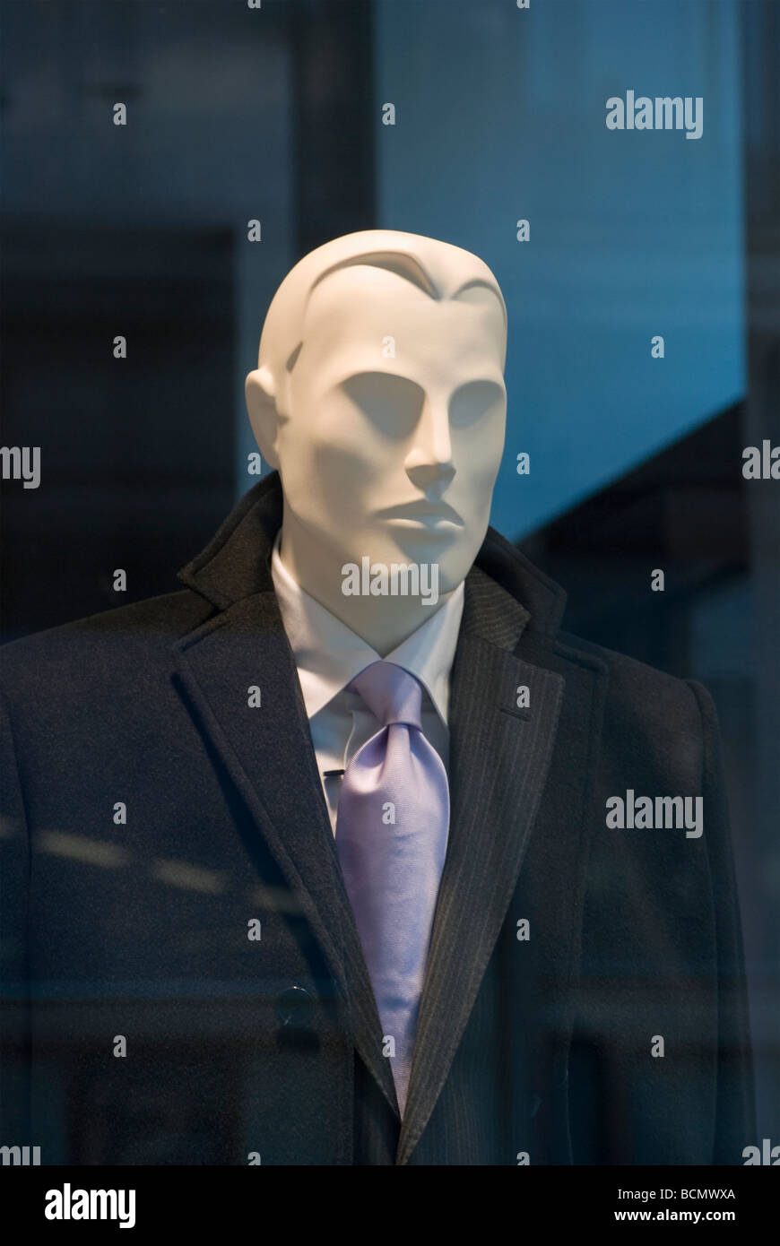 male mannequin with elegant clothes behind a luxurious shop window ...