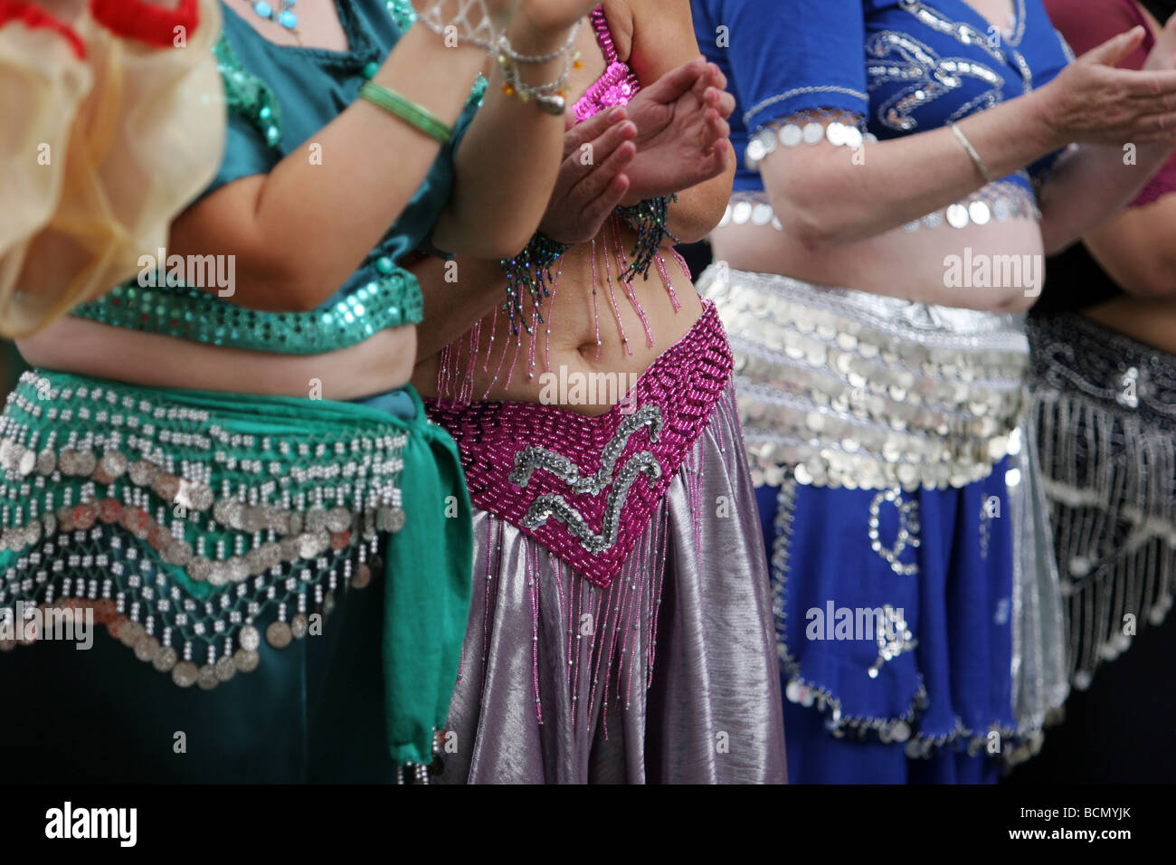 Close up detail of belly dancers in a public street in England Stock Photo
