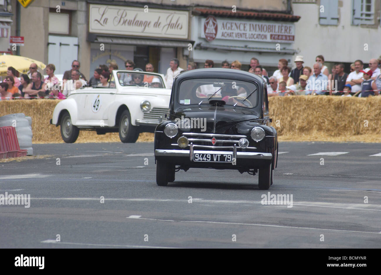 1950's classic Renault and Peugeot racing in the Bressuire classic car display and race event in France Stock Photo