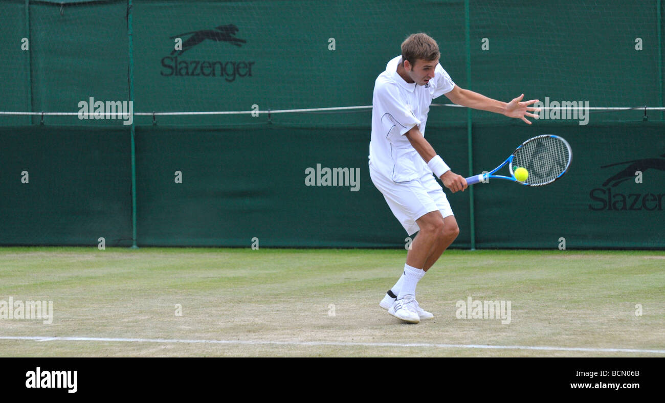 tennis player plays backhand return Stock Photo