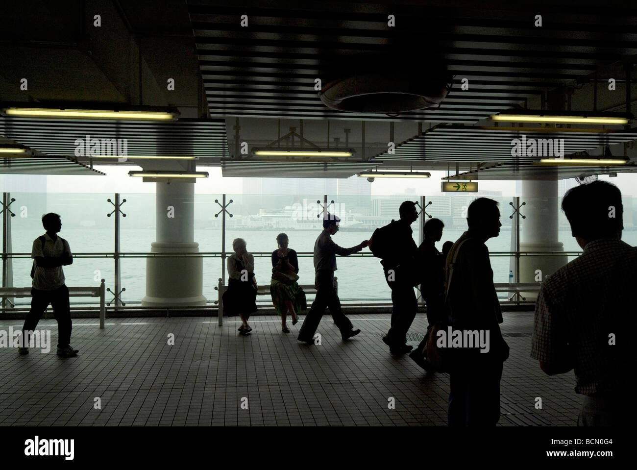 People walking toward Star Ferry dock, Hong Kong Island, Central District, Hong Kong, China Stock Photo