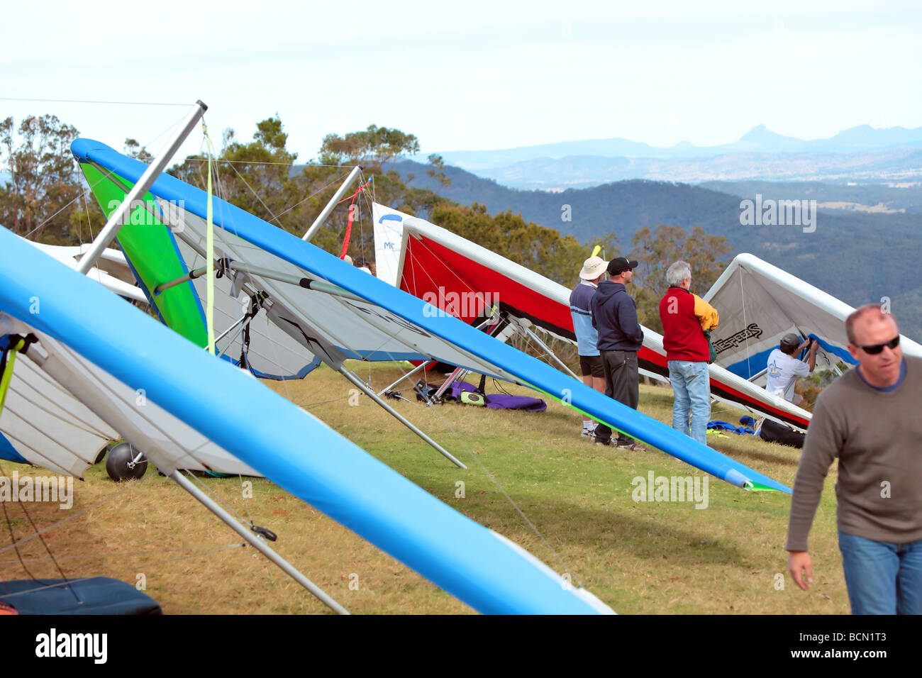 Pilots assembling their hang gliders prior to flight Stock Photo