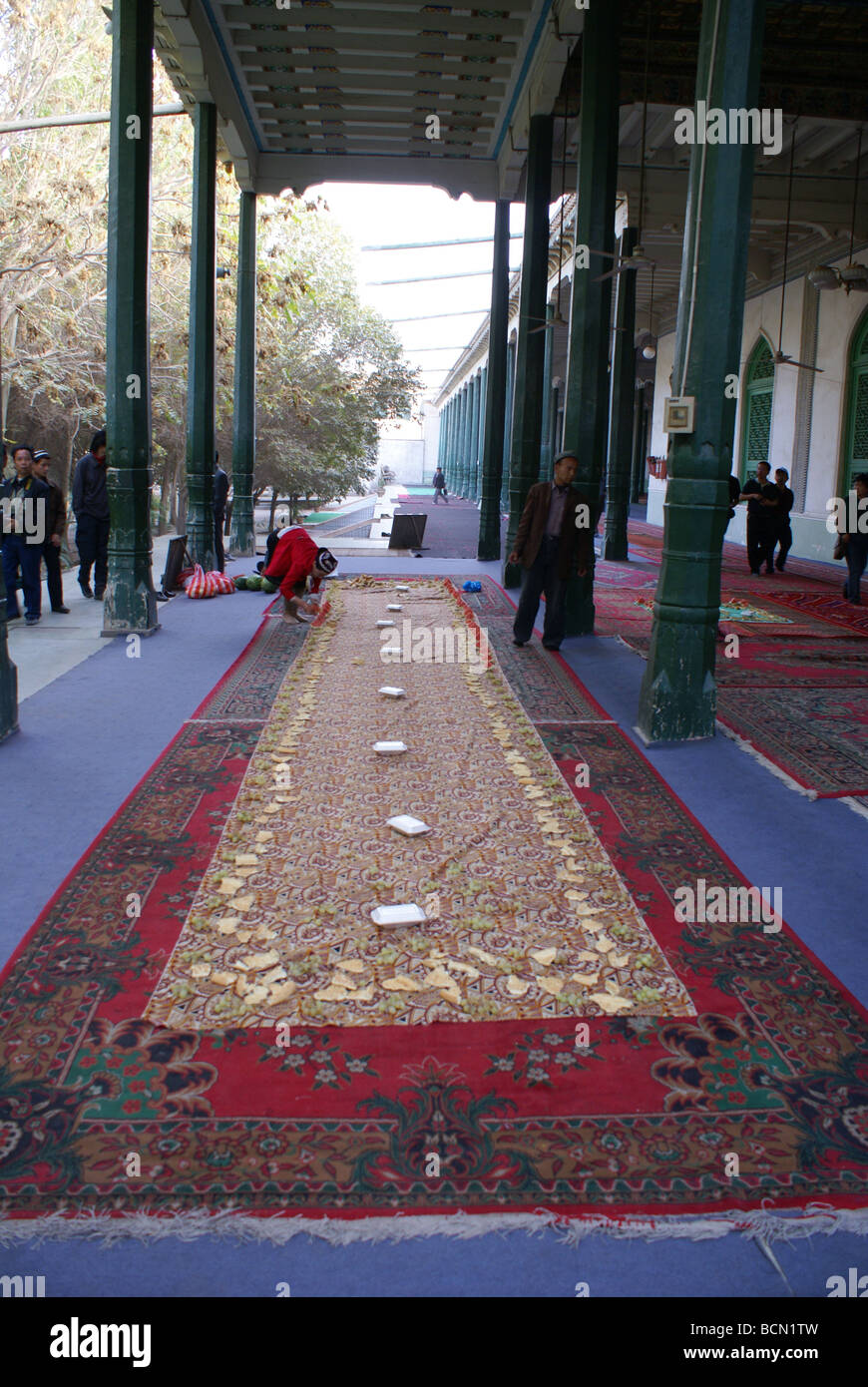 People laying down the carpet for prayer session in The Id Kah Mosque, Kashgar, Kashgar Prefecture, Xinjiang Uyghur Autonomous Stock Photo