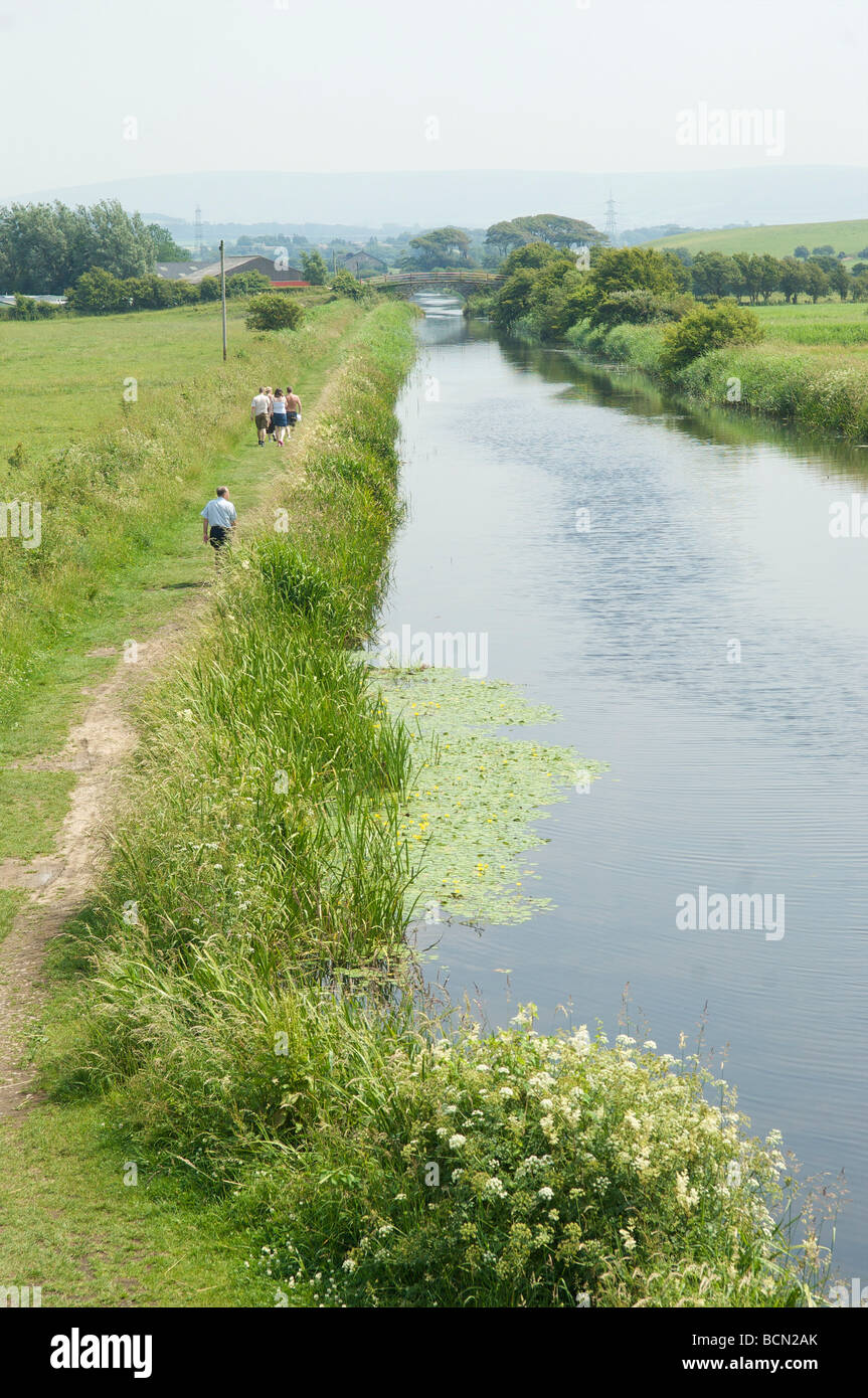 Walkers on the tow path on the Lancaster canal at Glasson Dock Stock Photo