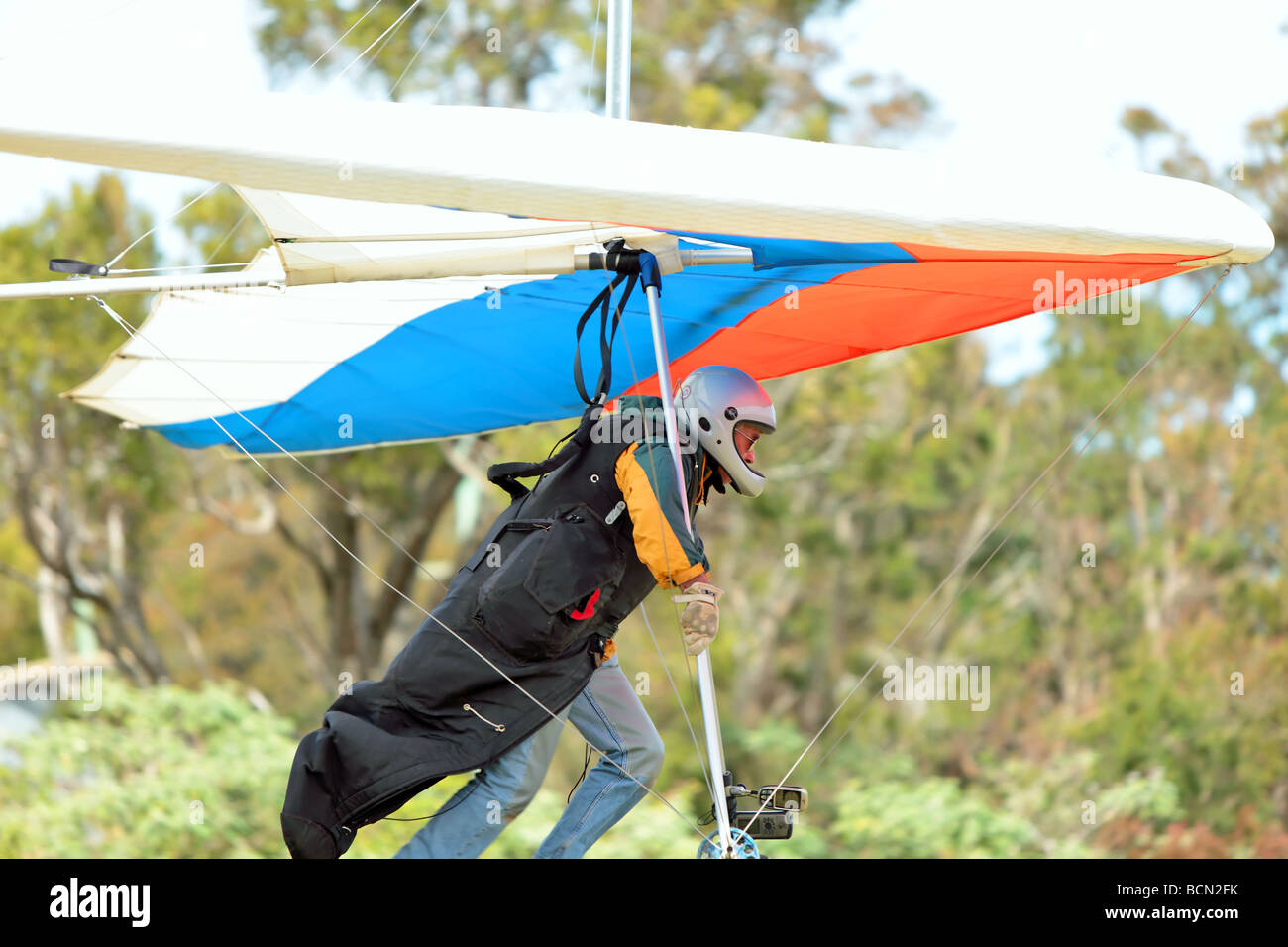 Pilot runs to get lift for his hang glider Stock Photo